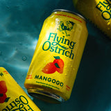 Three cans of Flying Ostrich Mango beer on a blue textured background
