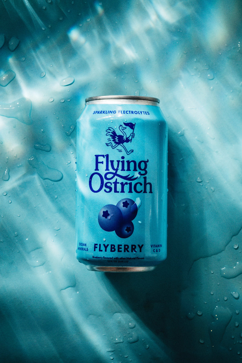 Blue can of 'Flying Ostrich' Flyberry on a textured blue background